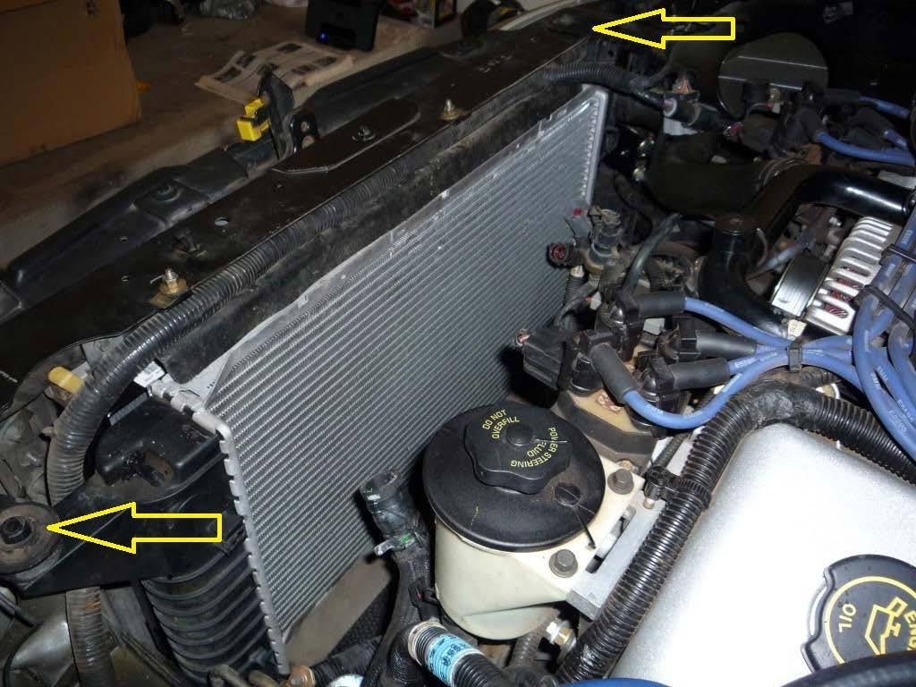 8. Remove the two bolts that hold on the fan shroud to the radiator about half way down each side of the shroud. Once bolts are removed, pull straight up to remove the fan/shroud assembly. 9.