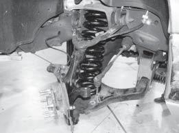 FIG. 10 31. Route the brake hose and ABS line behind the knuckle and attach to the threaded bosses on the back with ¼ x ¾ bolts, SAE fl at washers, and lock nuts from bolt pack #548.