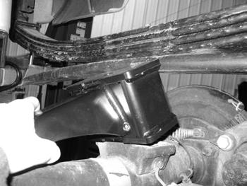 FIGURE 18 46. Repeat block installation of the driver s side. Take care not to over extend the brake lines. 47. Install the new shocks with the original mounting hardware. Tighten to 55 ft-lbs. 48.