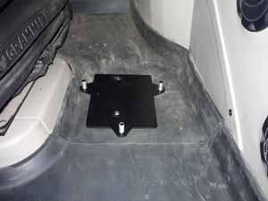NOTE: Position the bracket as close to the seat and as far back as possible in the cab, while ensuring the bracket is remains on the flat portion of the floor mat.