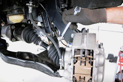 Install the front brake line relocation bracket using the 1/4 x 1 bolt and hardware from 1221BAG2