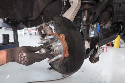 12. Using a 35mm socket, remove the axle nut and washer. Photo 7 13.