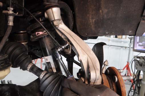 Using a 18mm wrench, loosen the upper ball joint nut, Do Not remove at this time.