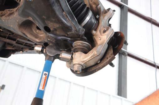 Using a 24mm wrench, loosen the lower ball joint nut, Do Not remove at this time.