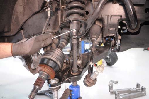 Remove the upper and lower ball joint nuts and remove the knuckle. See Photo 11. 17.