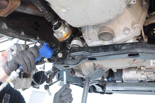 Using a 21mm socket and 21mm wrench, remove driver differential
