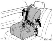 3. While pressing the convertible seat firmly against the seat cushion and seatback, let the shoulder belt retract as far as it will go to hold the convertible seat securely.