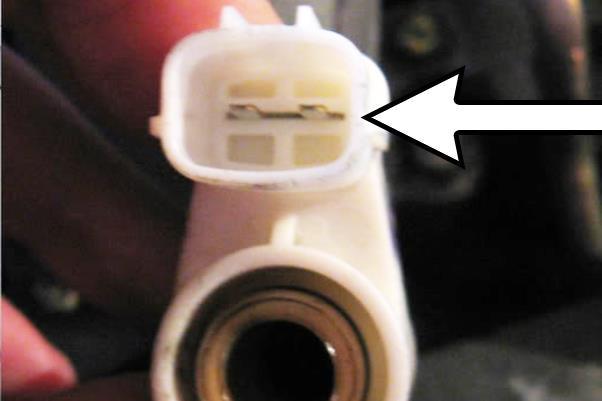 It will pop off as it has an internal O-ring seal. Using needle nose pliers, carefully pull to dislodge the small metal jumper shunt (shown) inside the PCV leak detection diagnosis connector.