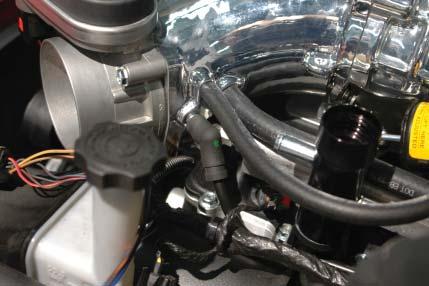 Route the right side intercooler hose over toward the left side of the engine com- partment and down below the AC lines.
