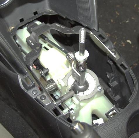 Figure 1a b) Remove the shift boot panel by grasping inside the boot (where