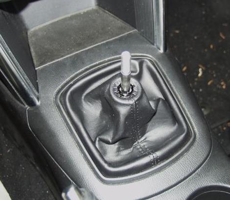 Set the bracket aside. Figure 1c d) Remove the cup holder panel.