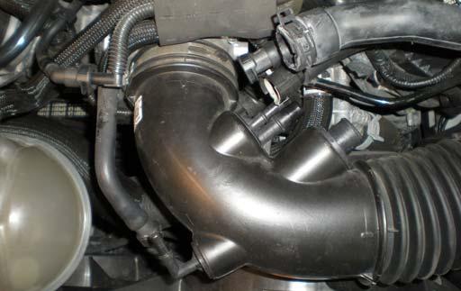 3. Remove the Idle Bypass Hose and the Evap Vent Hose (if equipped) by pushing in the release on