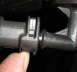 Remove the PCV hose by shifting the release tab to the left, see photo B.