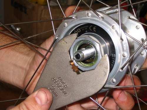 Then using a 32mm wrench grab the large nut on the drive side of the hub pictured below