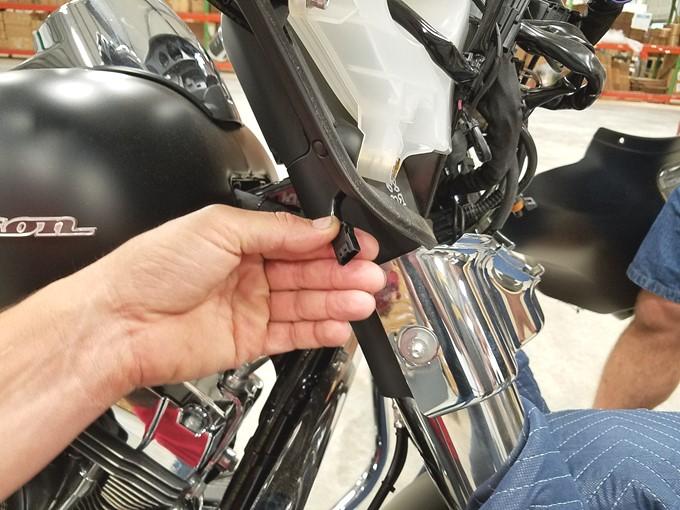 Plug the connector from the turn signal into the Pass-through harness, then reinstall the turn signal onto the fork frame and secure with the