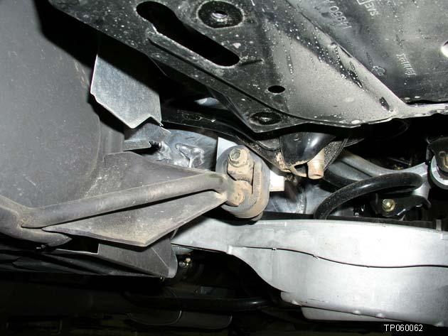 13. Remove the bolt that holds the passenger (RH) side rear muffler