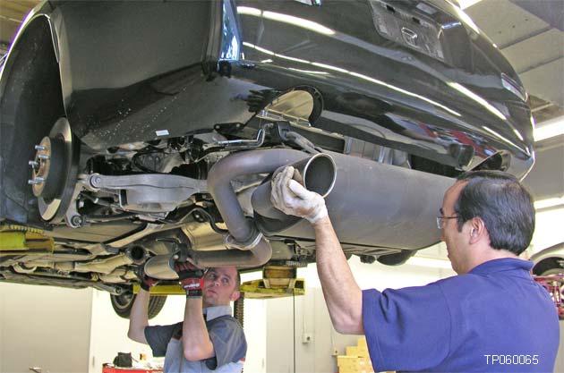 17. Carefully remove the exhaust center tube/rear muffler and place it in a safe location (see Figure 14).