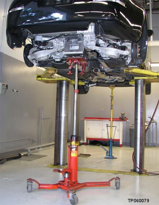 32. Place an additional support jack under the front suspension member to help stabilize the