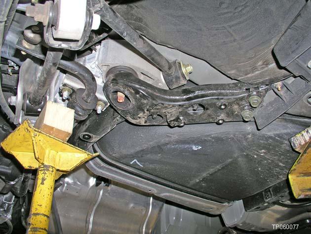 34. Place a support jack under the rear suspension member.