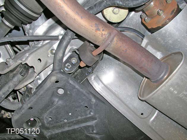9. Remove the nut that holds the center muffler mount bracket (see