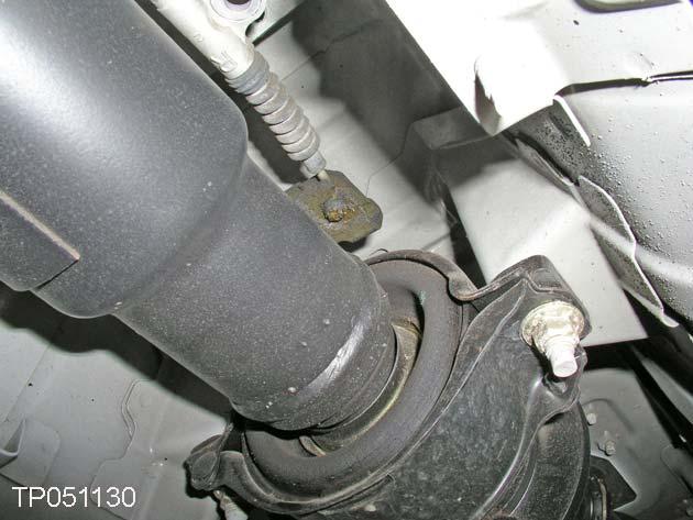 19. Remove the parking brake cables from the front