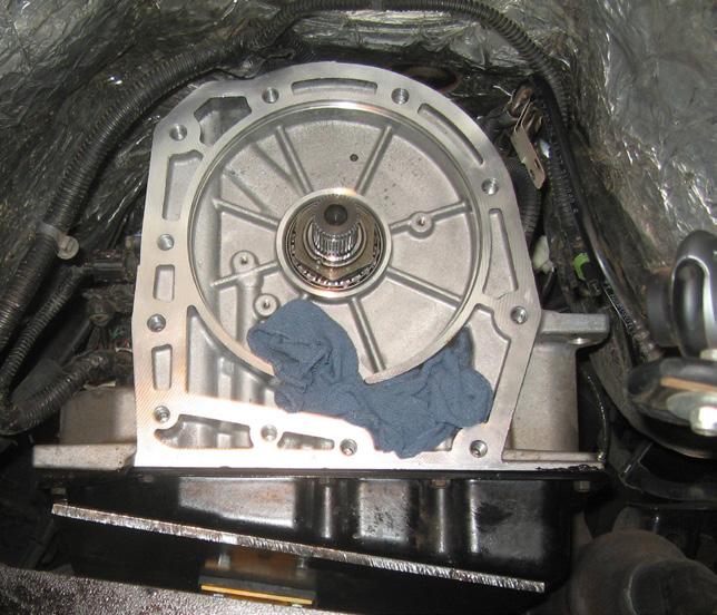 12. Remove the transmission tailhousing by removing the 11 hex head bolts and allow oil to drain for 10 minutes. 13.