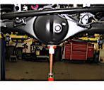 Then disconnect the shock absorbers from the rear axle assembly as shown.