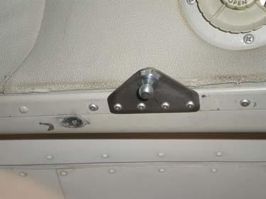 Place the remaining bracket under the top forward door sill with the ball stud attach hole inboard, measure aft from the center of the slide lock attach hole 1.125 and mark the sill.