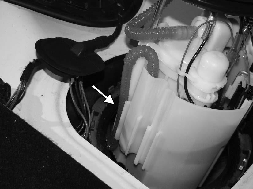 9) Lift the fuel pump basket out of the tank enough to separate the fuel line from the side of the