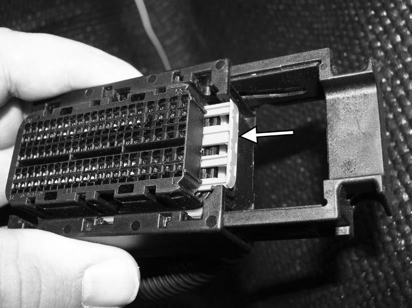 128) Reinstall the purple locking tab in the ECU connector, making sure the tab goes back in