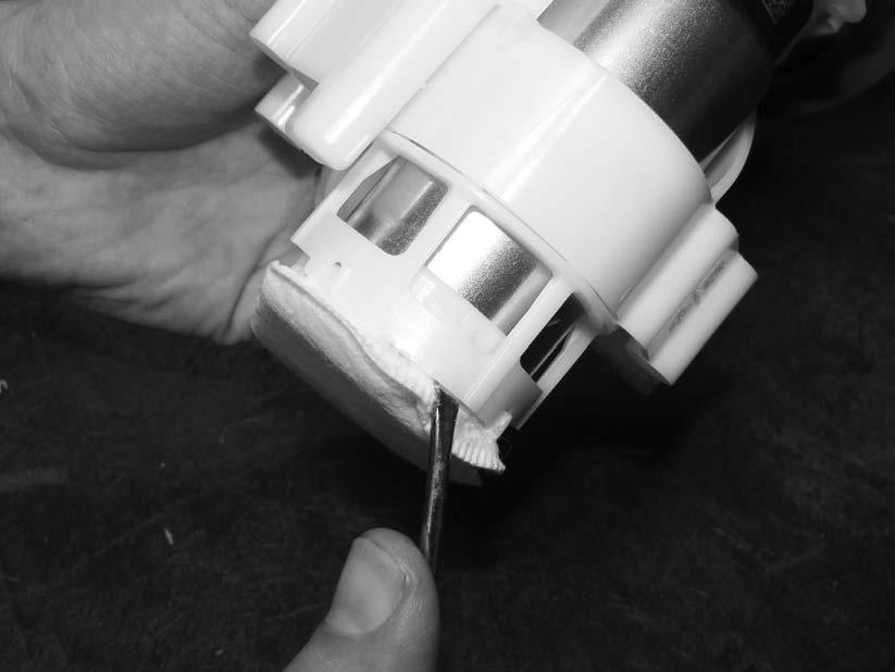 21) Once the two sides of the fuel pump sock are separated, remove the