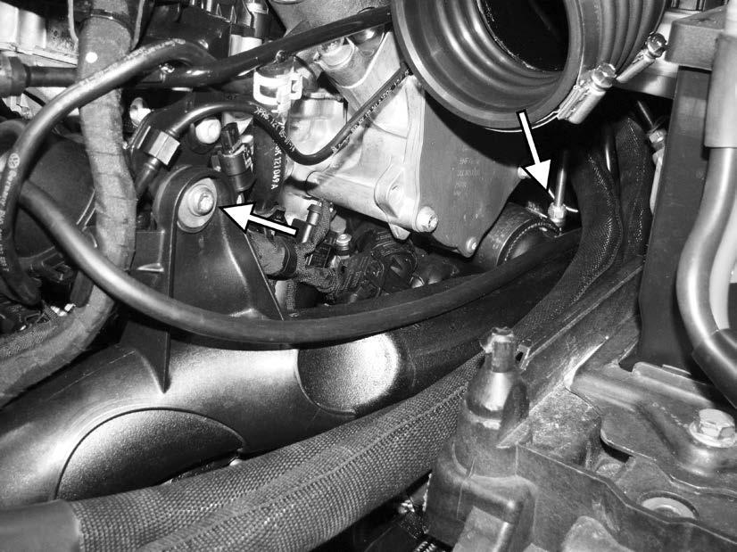 66) Unscrew the T30 screw that holds the turbo outlet pipe to the left side of the engine.