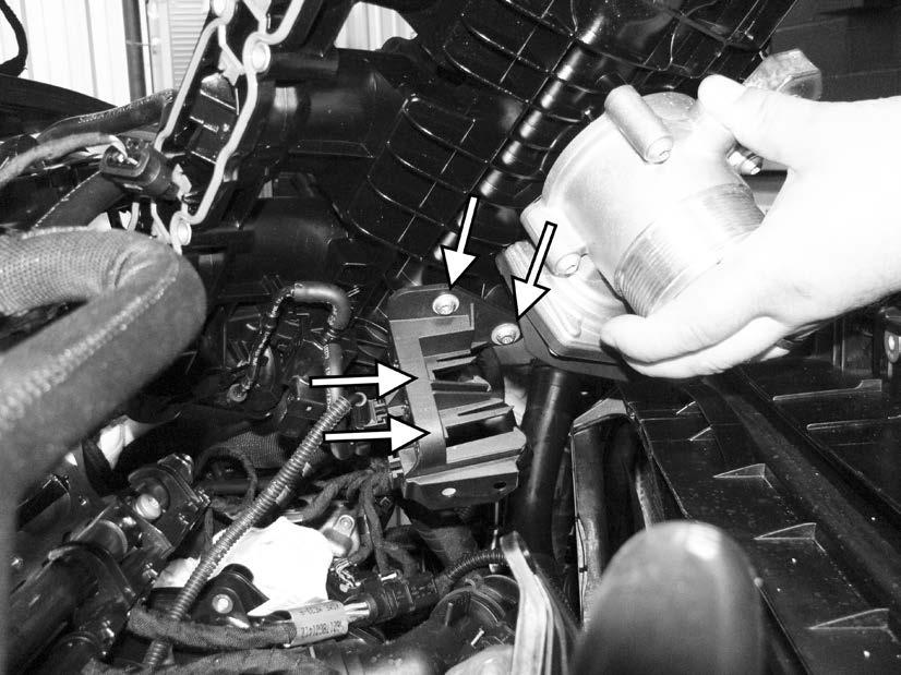 76) Lift the right side of the intake manifold up in order to access the connections on the bottom of the left side of the intake manifold.