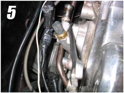 3) Remove Coil Pack from rear of engine. There are 2 upper bolts at each corner and one lower bolt in the middle of the bracket.