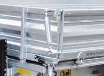 Storage compartment for 2 aluminium driveup ramps, integrated in the chassis frame Side wall lifting spring for side walls and lever for central locking Reinforced 12 t geared support winch with load