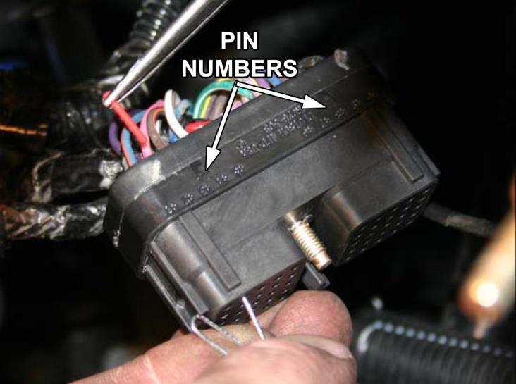 The easiest way to remove the OEM plug pins is to take the paper clip and insert it into the bottom end of the pin connector hole.