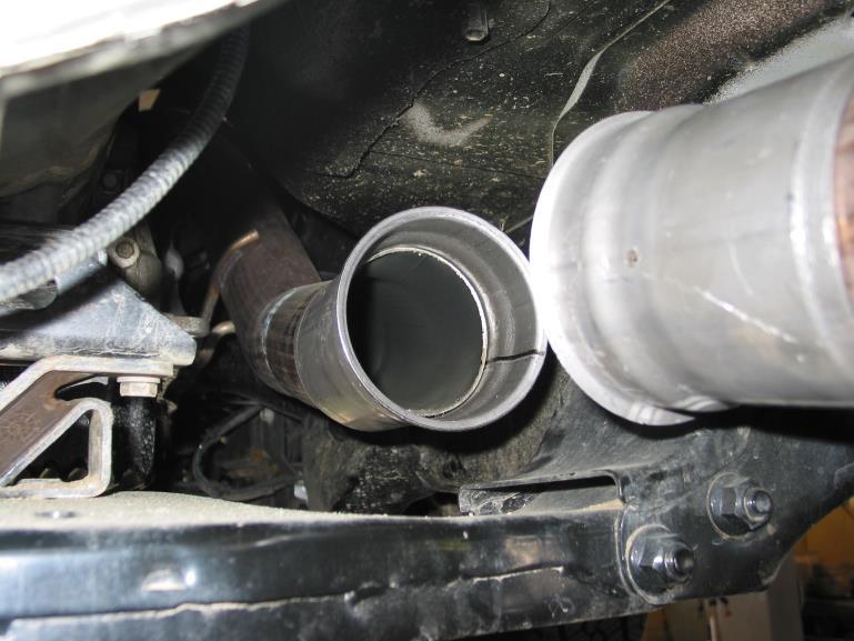 6 Insert the exhaust brake and secure with supplied V band clamps. Be sure that the air cylinder bracket extends toward the rear of the vehicle.