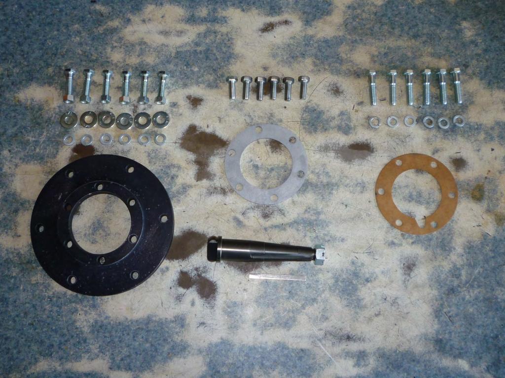 This photo shows the hardware that came with the Ryan Overdrive kit. The six bolts, nuts, and washers in the upper left are used to mount the adapter plate onto the back of the Ryan gear box.
