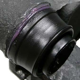 grease extrudes from between the brake caliper and the dust boot.