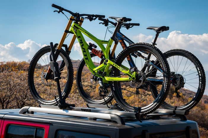 The vehicle below uses two Thule 594XT bike racks mounted directly to the slats to keep