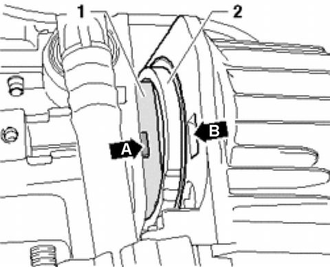 Insert piston head -1- partially into cylinder head -2-, align tab -arrow A- on pump body with notch -arrow B- in new cylinder head (from kit) and assemble parts