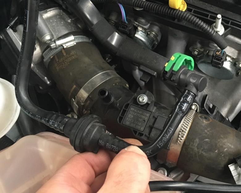 6. Identify this section of the emissions circuit hard-line, there is a 90 degree quick connect fitting with a PCV unit shortly downstream.