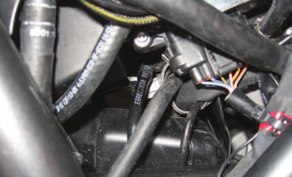 Route the harness on the inside of the frame and come out near the rear throttle body. FIG.