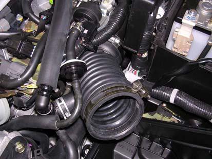 the rubber isolator rearward. Lift up on the lower air filter housing and remove.