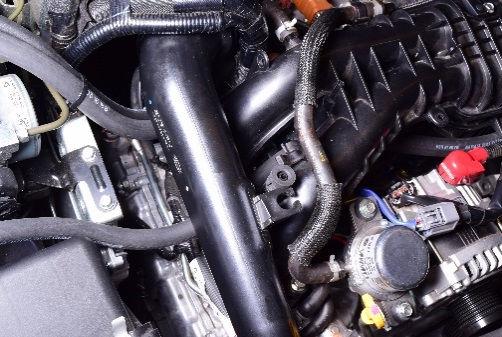 23 Route the hose between the #1 and 3 intake manifold runners and under the boost tube.