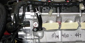 Remove the two foam fuel rail bumpers from the top of the manifold and discard them. 33.