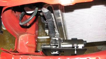 Route the rest of the hose around the A/C hard line, avoiding close proximity to the exhaust manifold and power steering pump,