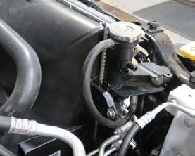 Lower the vehicle and remove the upper radiator hose using an appropriate