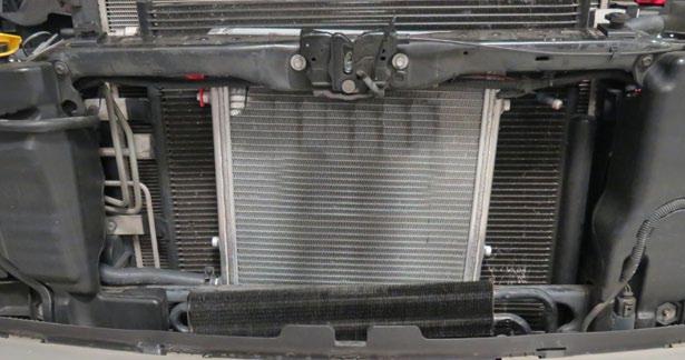 Carefully position the Low Temp Radiator (LTR) in front of the A/C