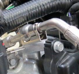 Using a hacksaw, remove the bracket from the fuel line.